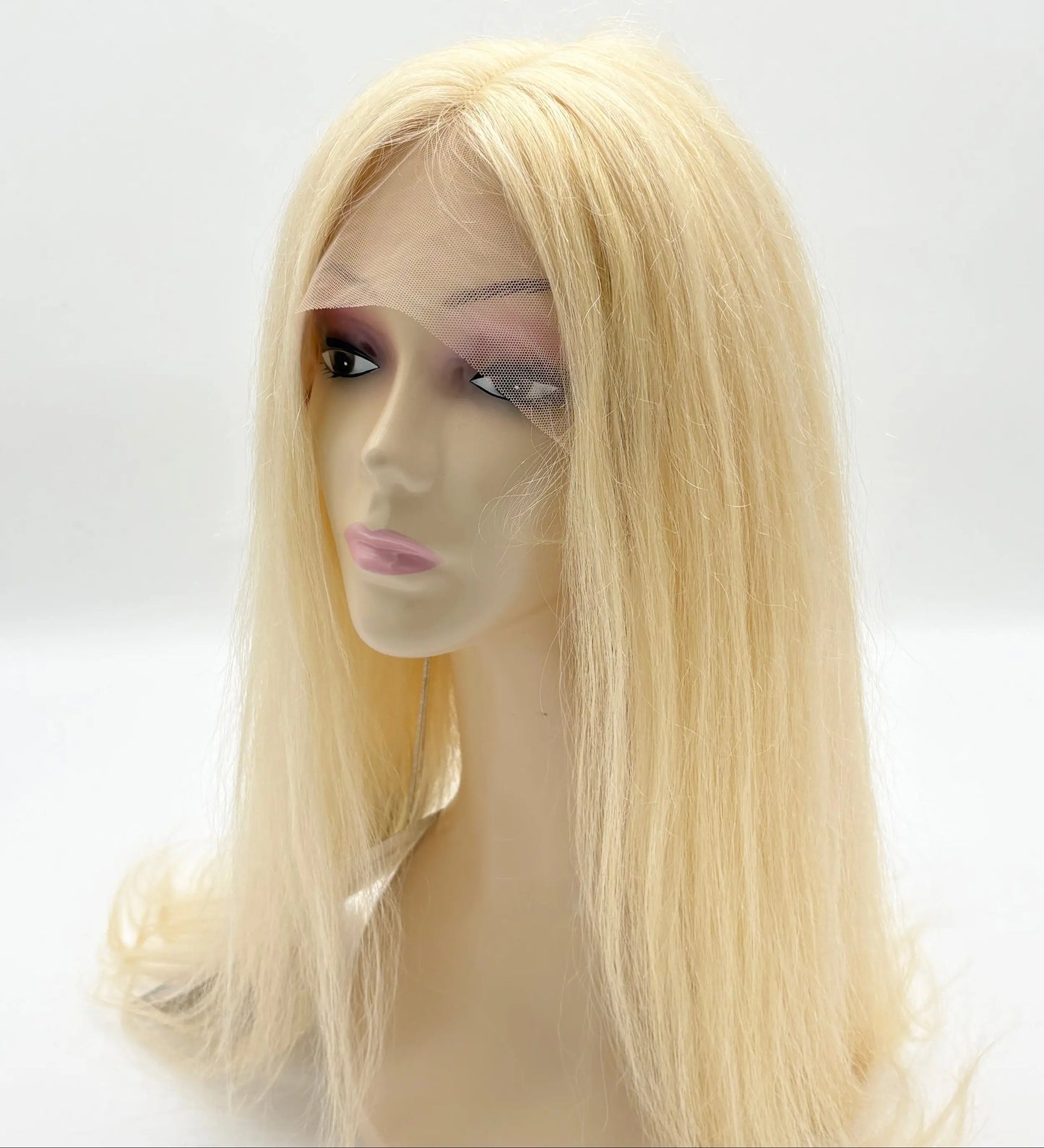 Blonde wig on a mannequin head against a white background