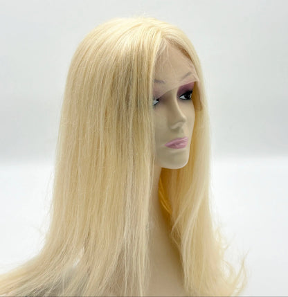 Blonde wig on a mannequin head against a white background