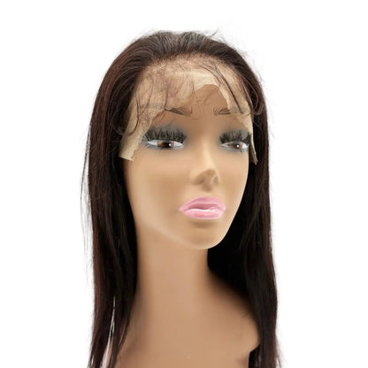 Mannequin head with a dark brown wig on a white background