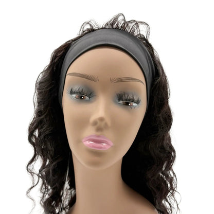 Mannequin head with a black wavy hairpiece on a white background