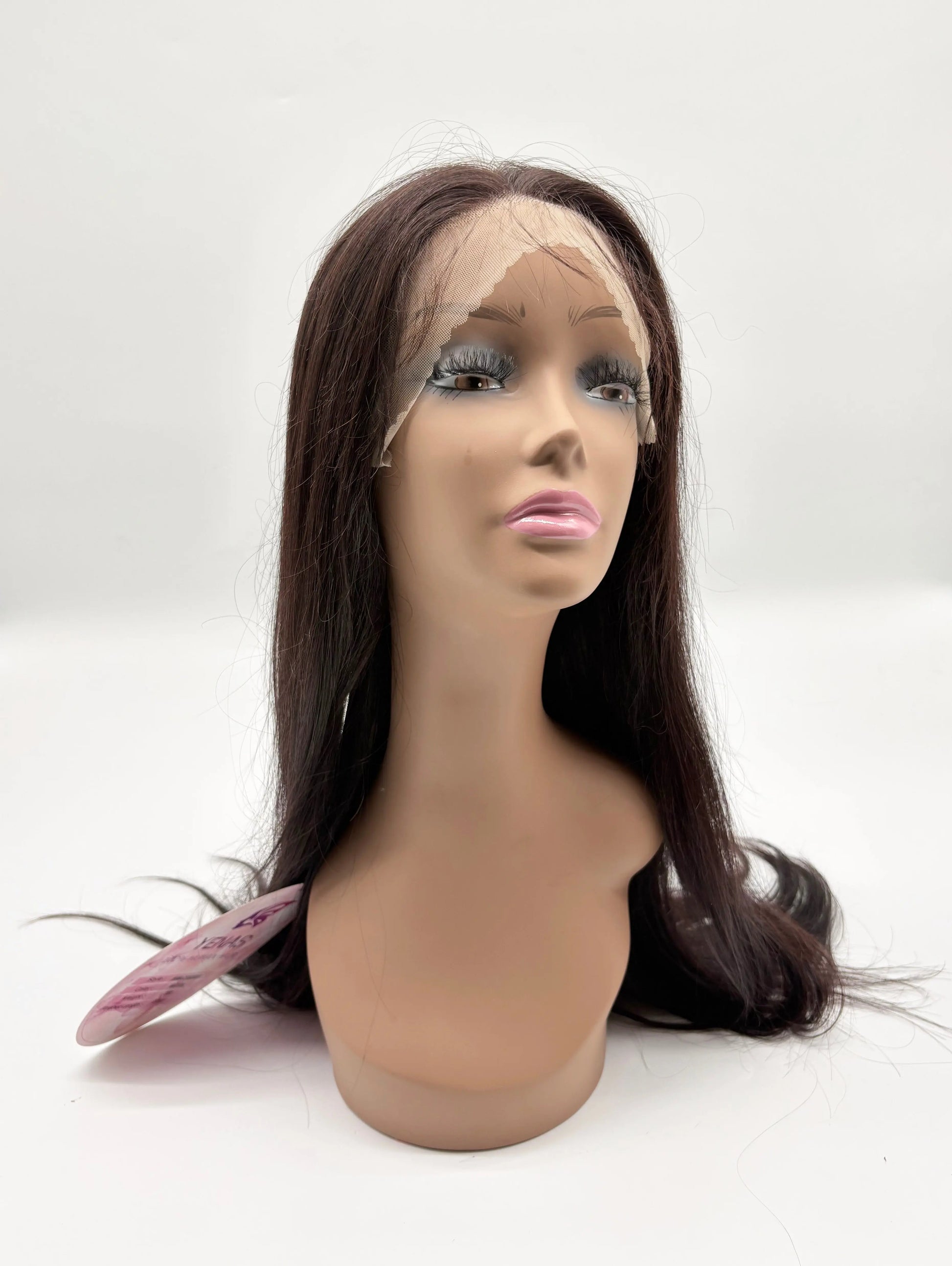 Mannequin head with a brown wig on a white background