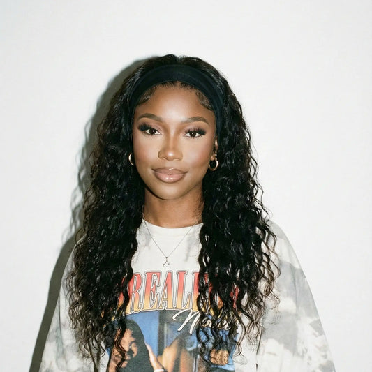 Person wearing a graphic t-shirt with a colorful design on a plain background