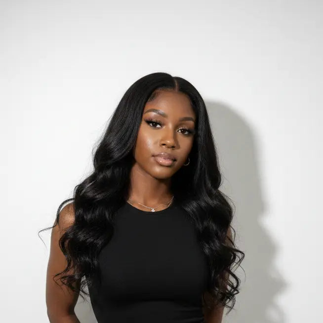 Woman wearing a black dress against a white background